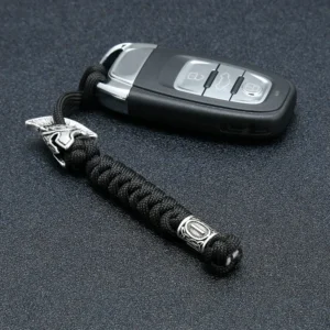 Dragonne de couteau en paracorde noire avec perle gravée de runes