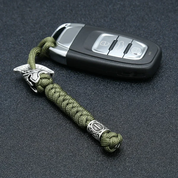 Dragonne de couteau en paracorde vert armée avec perle gravée de runes